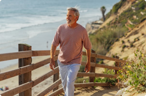 man walking along beach